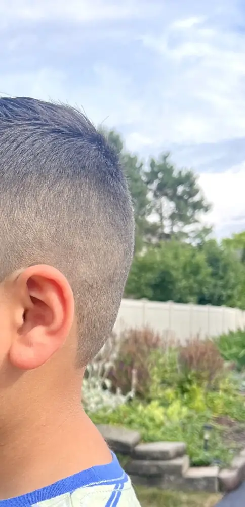 A young client’s fresh taper from Axis Cuts, side view