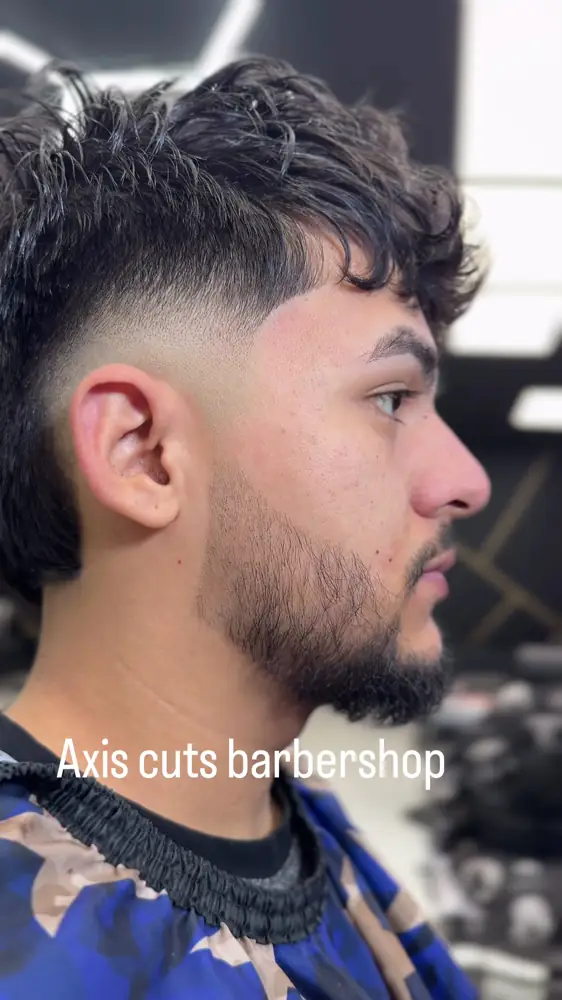 Mid fade with textured top and a shaped beard at Axis Cuts